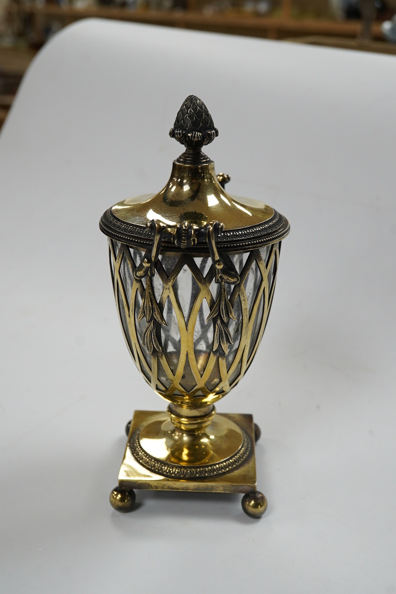 A George V pierced silver gilt two handled sugar vase and cover, by Holland, Aldwinckle & Slater, London, 1912, with clear glass liner, height 17.7cm, 9.7oz. Condition - fair to good